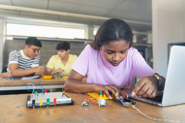 istock Black female teenager Student programming electronics robotics in the technology course 1430137916