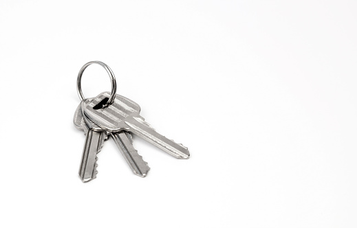 Three keys to the apartment. Close up of keys on a white background