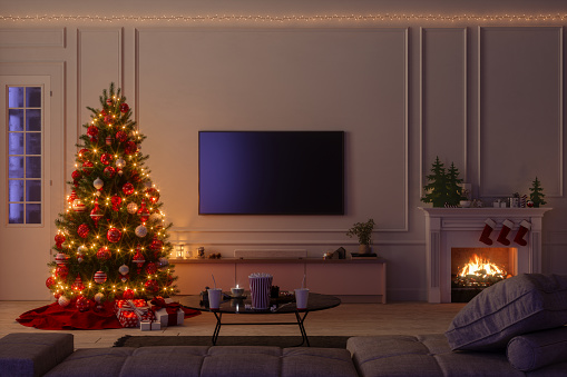 Modern Living Room Interior With Christmas Tree, Ornaments, Gift Boxes, Sofa And Lcd Tv Set At Night