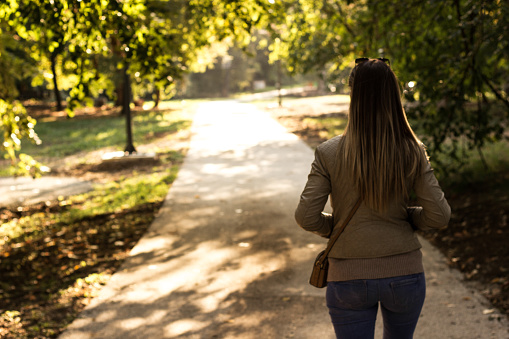 Woman walks towards the light, beauty in nature