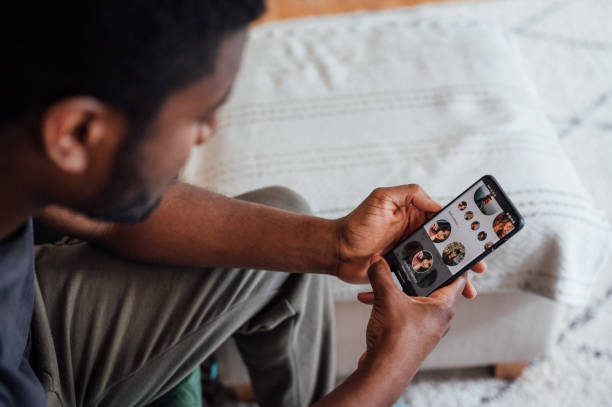 Young man using a dating app stock photo