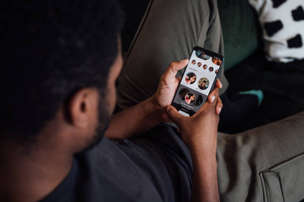 Young man using a dating app stock photo