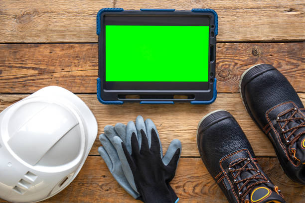 istock Builder uniform and digital tablet on wooden background, flat lay. 1430142515