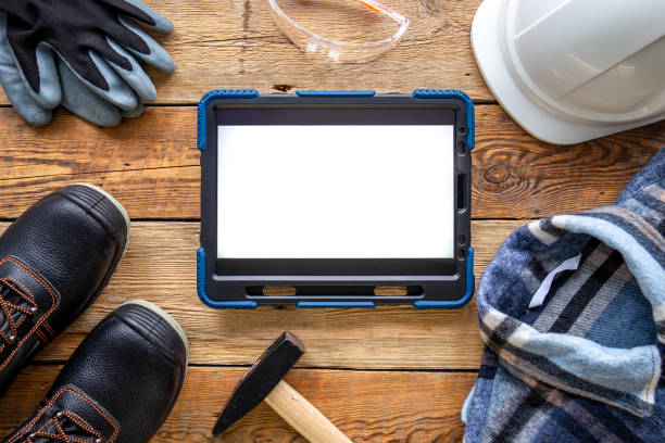 istock Builder uniform and digital tablet on wooden background, flat lay. 1430142525