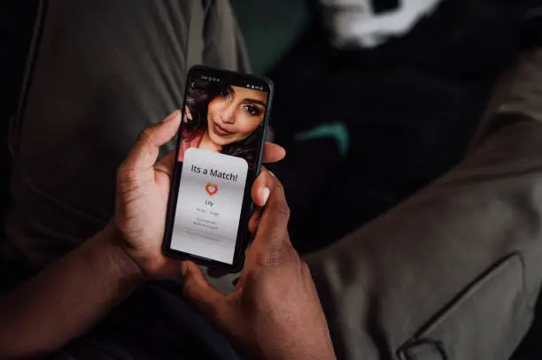 Photo of Young man using a dating app