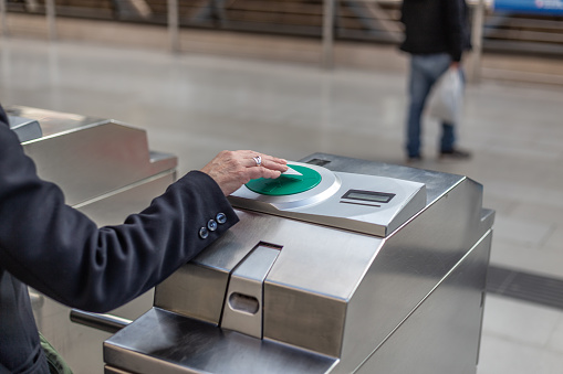 Madrid Spain. April 6, 2022. Woman's hand using public transport card to access metro station