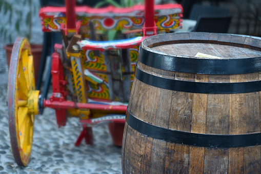 A wooden barrel in a characteristic Sicilian alley
