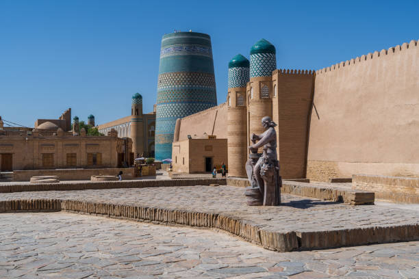 Khiva Kalta Minor minaret and old town surroundings Khiva Kalta Minor minaret and old town surroundings khiva stock pictures, royalty-free photos & images