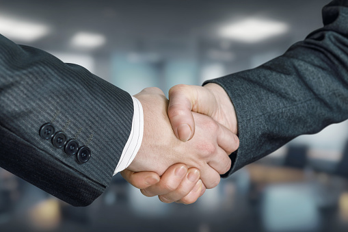 The concept of cooperation between businessmen as a result of a handshake.
