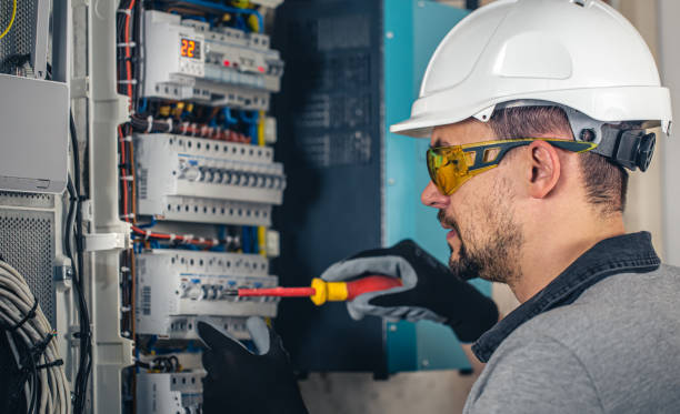 istock Man, an electrical technician working in a switchboard with fuses. 1430150467