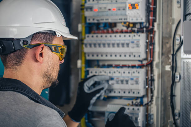 istock Man, an electrical technician working in a switchboard with fuses. 1430150472