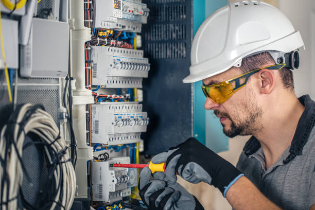 istock Man, an electrical technician working in a switchboard with fuses. 1430150473