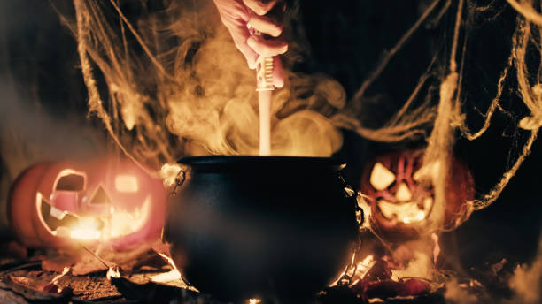 istock Pot with magic smoke coming out and halloween pumpkins 1430150532