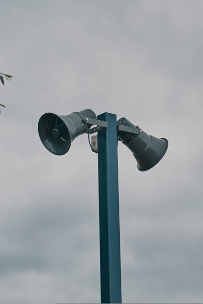 istock Tall column with two loudspeakers against cloudy sky. 1430150560