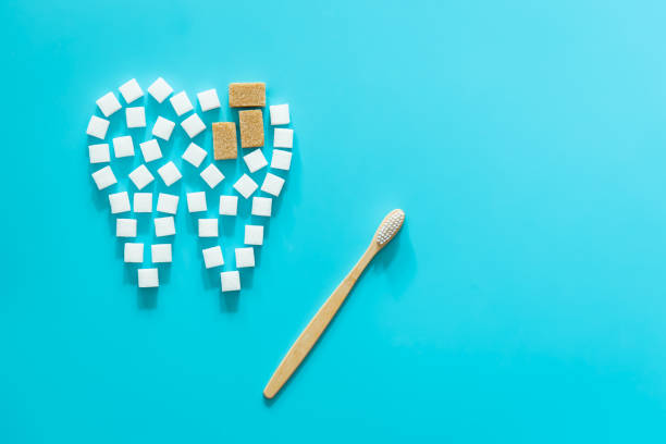 istock Flat lay, tooth made of sugar on a blue background. 1430151472