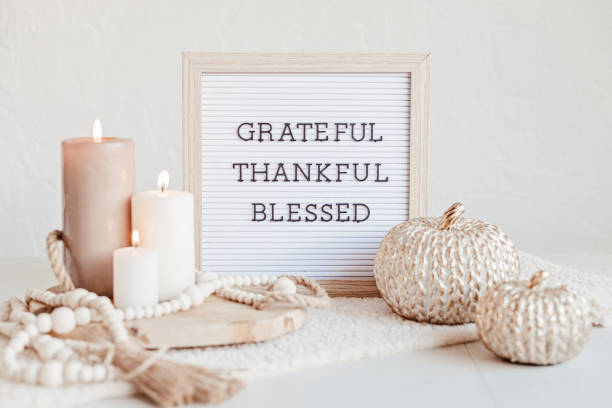 istock Felt letter board and text grateful, thankful, blessed. Autumn table decoration. Floral interior decor for fall holidays with handmade pumpkins 1430155661