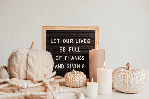 Felt letter board and text let our lives be full of thanks and giving. Autumn table decoration. Interior decor for thanksgiving and fall holidays with handmade pumpkins and candles Felt letter board and text let our lives be full of thanks and giving. Autumn table decoration. Interior decor for thanksgiving and fall holidays with handmade pumpkins and candles happy thanksgiving stock pictures, royalty-free photos & images