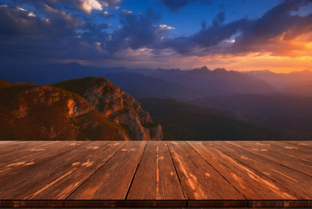Sunrise over Mountains with empty wooden table. Natural template landscape stock photo