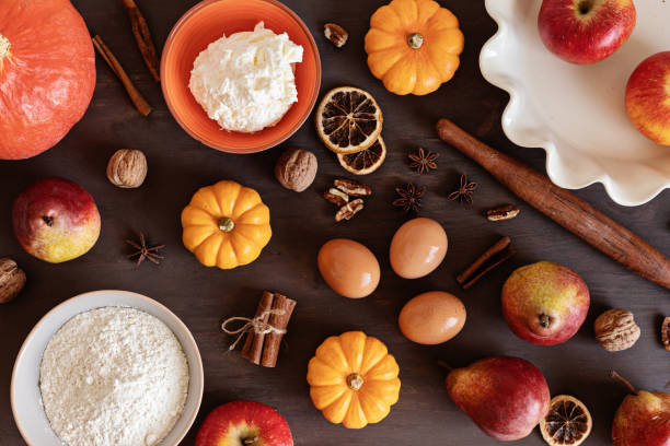 istock Fall pie baking ingredients with pumpkins, apples, pears, nuts, seasonal spices and tools. Cooking pumpkin or apple pie. Thanksgiving and autumn holidays celebration concept 1430155998