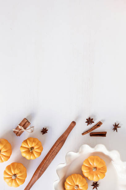 istock Fall pie baking ingredients with pumpkins and seasonal spices and tools. Pumpkin pie recipe idea. Thanksgiving and autumn holidays celebration concept. Top view, flatlay 1430156004
