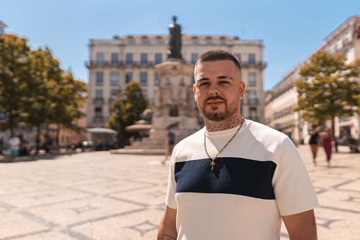 Portrait of serious young man in the square in Lisbon, Portugal