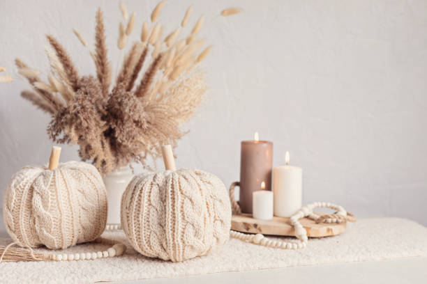 istock Autumn table decoration. Interior decor for fall holidays with handmade pumpkins and candles. Holiday greeting card 1430163275