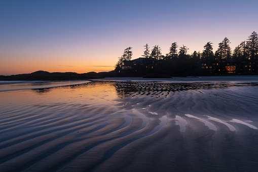 Sunset on Chesterman Beach by the Pacific Ocean near Tofino, Vancouver Island, British Columbia, Canada.