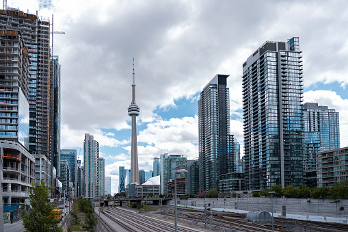 Toronto, Canada - May 28 2022: Toronto skyline with cn tower and financial glass buildings on cloudy day