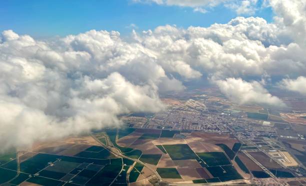 Flying Above the clouds looking down on farm land