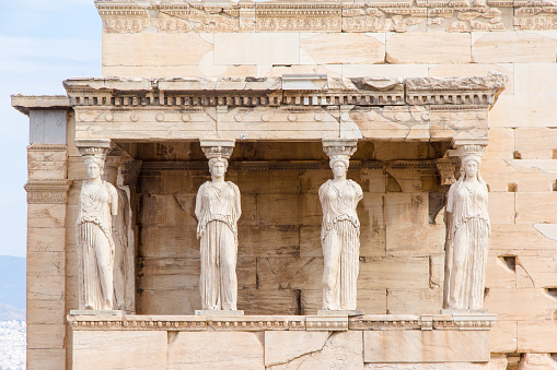 The Erechtheion or Temple of Athena Polias, the Ancient Greek temple at the Acropolis in Athens. The columns that support the porch are six female figures.