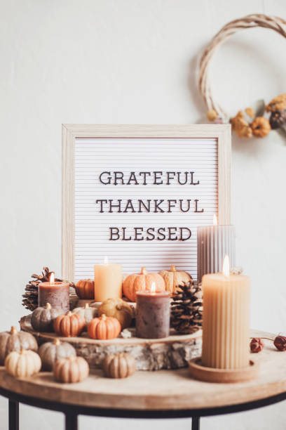 istock Felt letter board and text grateful, thankful, blessed. Autumn table decoration. Floral interior decor for fall holidays with handmade pumpkins 1430171256