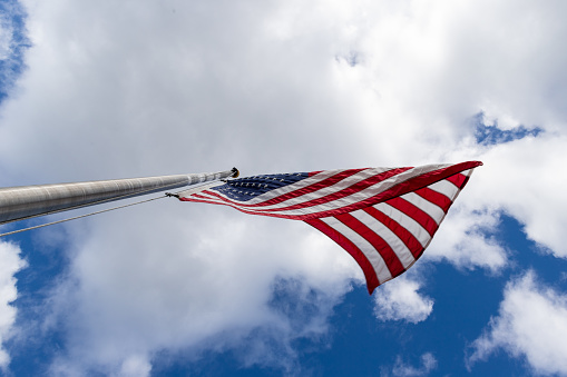 Six waving flags of USA on sky and clouds background. Banner wide photo.