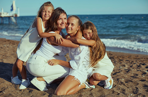 Family portrait. Woman smile. Two sisters and brother outdoors. Grandparent and children together. Summer vacation. Outdoor recreation. Leisure activity. Age. Grandmother and grandchildren