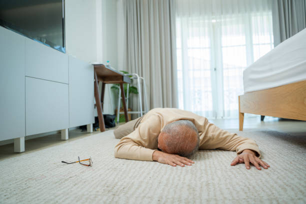 Asian senior male falling on the ground.