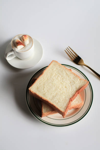 istock Slice Bread with hot coffee and marshmallow on white background.  Morning breakfast with coffee, butter and toasts. 1430176793