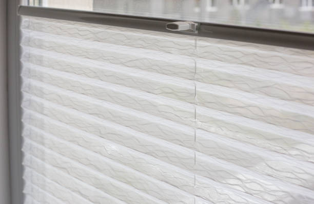 istock Pleated blinds close up on the window in the interior 1430182665