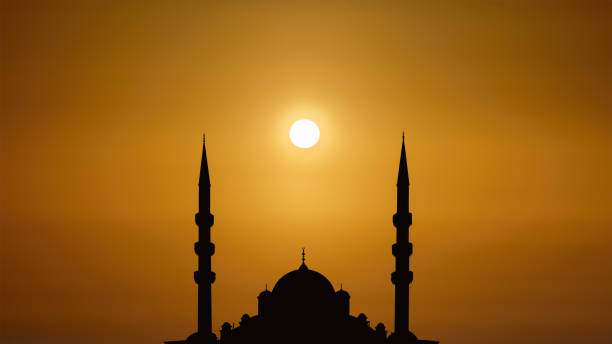 istock silhouette islamic mosque with dome and two tower with background of sunrising 1430188206