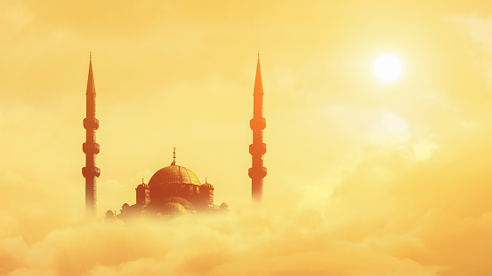 islamic background of silhouette islamic mosque over sky with cloud and sunrise sky background