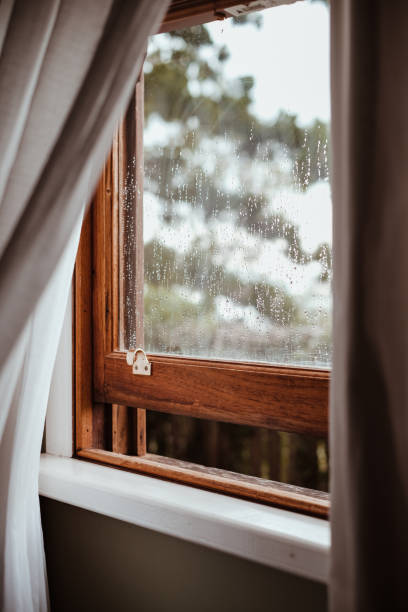 istock Open window in wooden frame with raining weather outside 1430188421