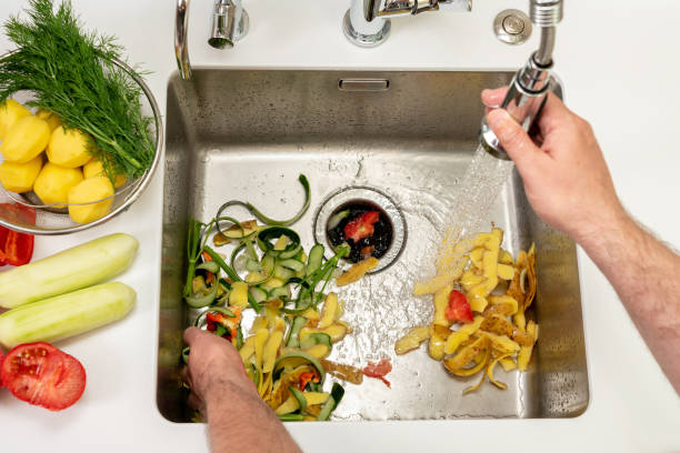 istock Working kitchen disposer on a modern sink to remove food waste 1430190560