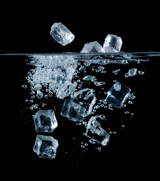 istock Ice cubes into the water with a bubble on black background 1430192714