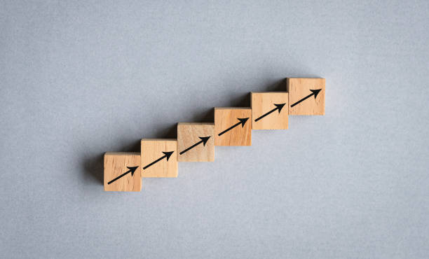 istock Arrows on wood cubes arranged as step stair going up. 1430193192
