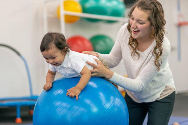 istock Pediatric physical therapist doing work with her toddler patient 1430207008