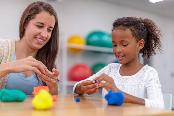 istock Young ethnic girl working on her balance with a physical therapist 1430207066