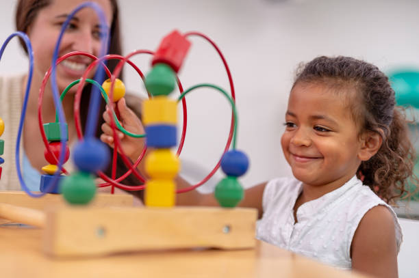 istock Ethnic pre-schooler working with her teacher in a classroom 1430207079