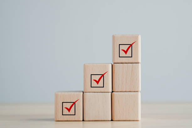 istock Checklist, Task list, Survey and assessment, Quality Control, Goals achievement and business success. Elections and Voting, Vote, to do list, Red check mark on stack of wooden block. 1430207160