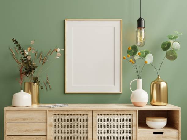 istock Mock up poster frame on cabinet in living room interior on empty green wall background. 1430209054
