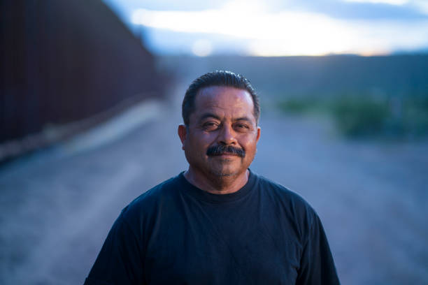 istock Confident mexican man standing by the border wall between New Mexico and Juarez - Mexico 1430209084