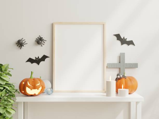 istock Mock up poster frame on white table with halloween decoration have white wall background. 1430209095