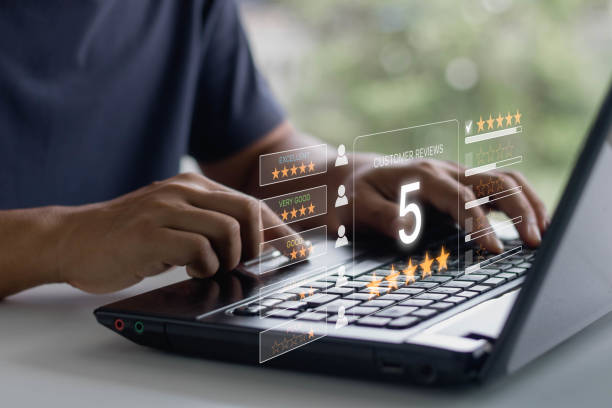 Man hand using laptop computer with popup five star icon for feedback review satisfaction service, Customer service experience and business satisfaction survey.